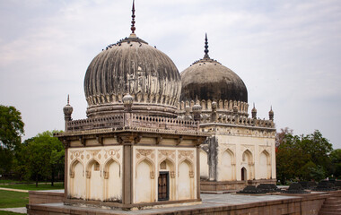 Fototapeta na wymiar View of giant tomb buildings in the vast area of Qutb Shahi Archaeological Park, Hyderabad, India