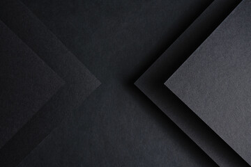 dark background on black paper with an image of triangles on both sides