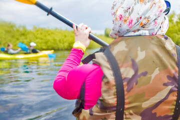 Water Activities. Closeup of Female Traveller Holding Kayak Paddle While Kayaking On River Outdoors.
