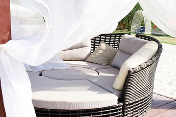 Beach party area with soft sofas and curtains
