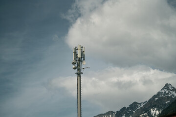Obraz premium Telecom Tower 5G and 4G Cellular Networks in the sky. cell tower over a forested rural area