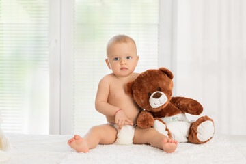 Baby hugging his teddy bear