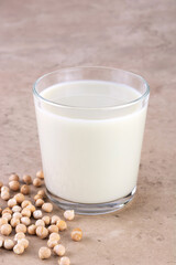 Chickpea milk with chickpeas on a beige background. Lactose free milk. Alternative dairy product.