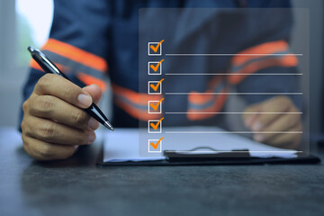 industrial or shipping inspector auditor supervisor in a reflective jacket writing a pen on...