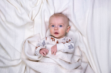 Cute baby boy 5 months old on a light background