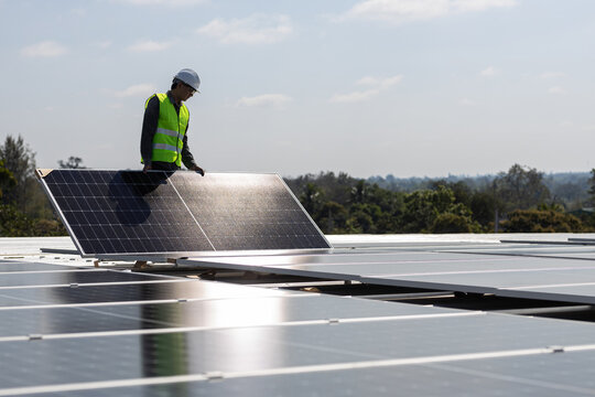 A Technician Installing The Solar Panels At Roof Top Of Home And Home Office ,concept Of Economic Energy And Cost Saving ,own Small Business