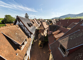 Fototapeta premium Aerial Shot of Street in Eguisheim village in the Alsace province, France. Picturesque village in a Sunny Summer Day