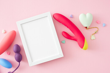 Adult-oriented erotic toy ideas. Top view photo of vibrators, anal plugs, vaginal balls, little hearts on pastel pink background with empty frame for text or promo