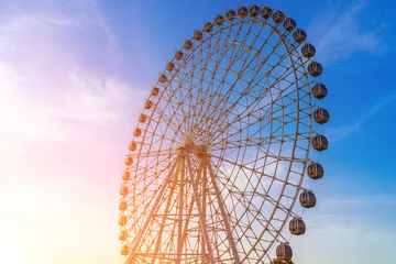 Deurstickers High ferris wheel at sunset or sunrise with cloudy sky background. © Eugene_Photo