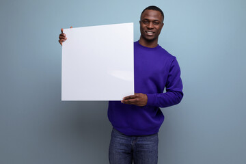 successful handsome young american business man in blue sweatshirt holding white placard mockup