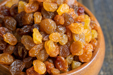 Dried yellow golden raisins on a board