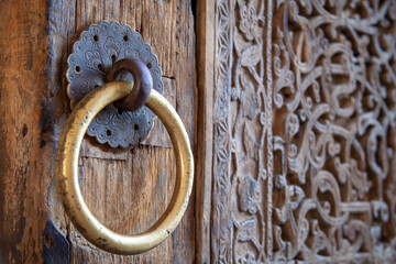 a wooden door with a golden ring