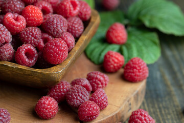 Ripe raspberries on a wooden board