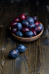Ripe plums on the table in the kitchen