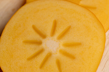 Half-cut ripe and sweet persimmon, close up