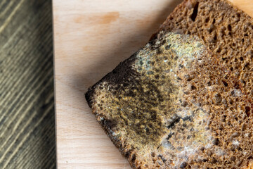 Black rye bread in mold on the board