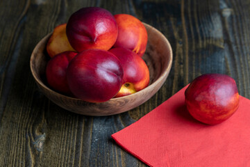 Nectarines folded in a wooden bowl