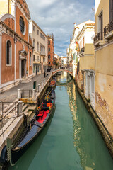 The Venice canal with gondola in the old town at sunny day.