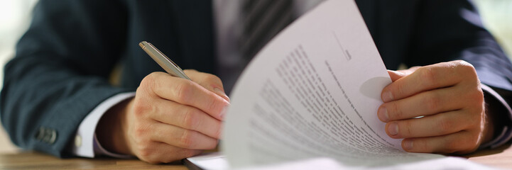 Businessman leafing through documents and signing contract for business deal at work in office closeup. Certification of documentation and control concept - obrazy, fototapety, plakaty
