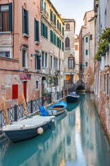 Fototapeta na wymiar The canal with a boats in Venice, Italy, Europe.