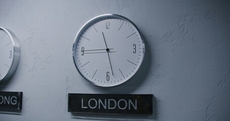 White watches with running time pointers show time zones of different cities. Walking wall clocks...