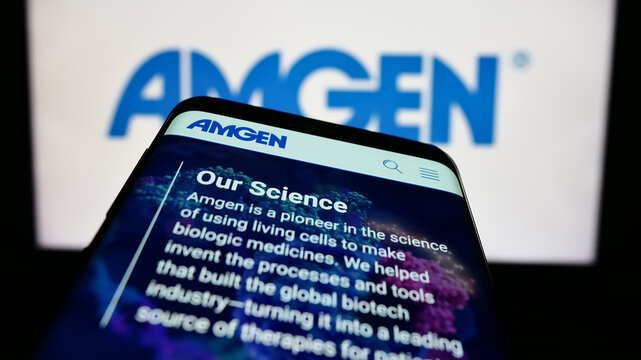 Stuttgart, Germany - 06-17-2023: Mobile phone with webpage of US biopharmaceutical company Amgen Inc. on screen in front of business logo. Focus on top-left of phone display.