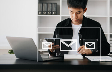 Asian Man hands using Laptop, tablet typing on keyboard and surfing the internet with email icon,...