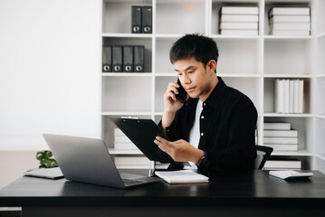 Fototapeta premium Asian business man executive manager looking at laptop watching online webinar training or having virtual meeting video conference doing market research working .