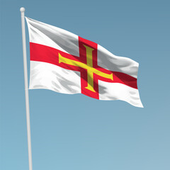 Waving flag of Guernsey on flagpole. Template for independence