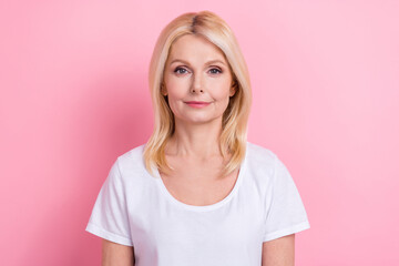 Portrait of gorgeous middle age lady wearing white default t-shirt posing for makeup magazine advert isolated on pink color background