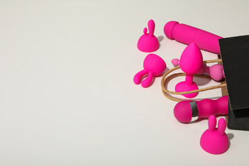Sex toys spill out of a paper bag, side view