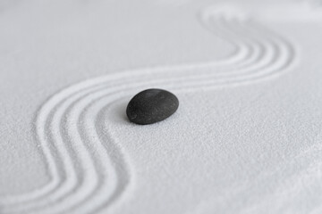 Fototapeta na wymiar Zen Garden with Grey stone on White Sand Wave Pattern in Japanese stye, Rock Sea Stone on Sand texture with the wave parallel lines pattern,Harmony,Meditation,Zen like concept
