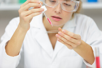 woman scientist with pipette in lab