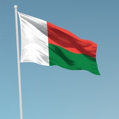 Waving flag of Madagascar on flagpole. Template for independence day