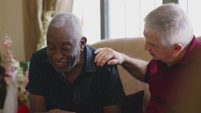 African American Senior Leaning on Friend for Support During Difficult Times. Person suffering from mental illness in old age, candid embrace