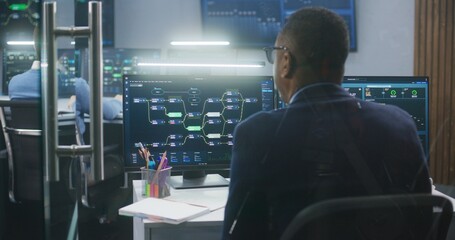 Technical support specialists sit at computers with displayed blockchain network map and server data. Big data scientists work in monitoring room. Big screens on the wall. Concept of cyber security.
