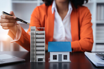 House model with agent asking costumer for contract to buy, get insurance or loan real estate or...