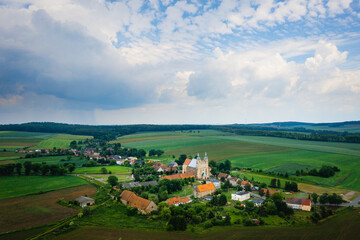 Fototapeta na wymiar Bobolice, aerial view of polish village and sanctuary of Lady of Bobolica, Lower Silesian landscape. Drone view of beautiful, countryside landscape with church.