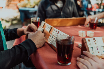A group of men drink traditional Turkish tea and play a Turkish game called Okey