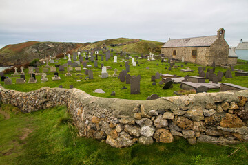Welsh chapel with graveyard and stone wall.