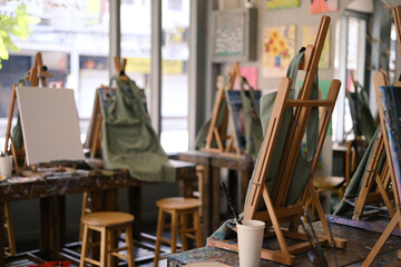 Interior of the creative art workshop with wooden easels and painting equipment - Powered by Adobe