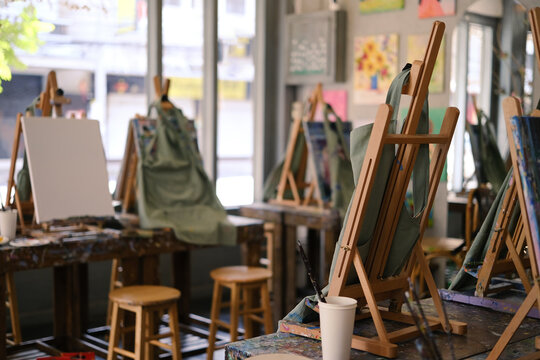 Interior of the creative art workshop with wooden easels and painting equipment