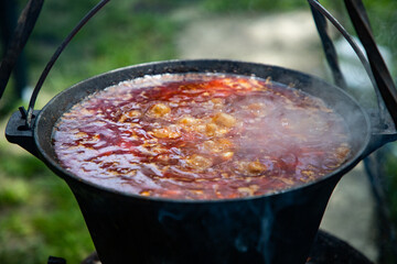 boiling chili con carne in a cauldron
