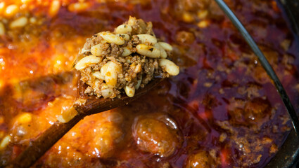 boiling chili con carne in a cauldron