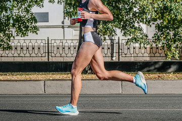side view female runner athlete running city marathon race, summer sports games