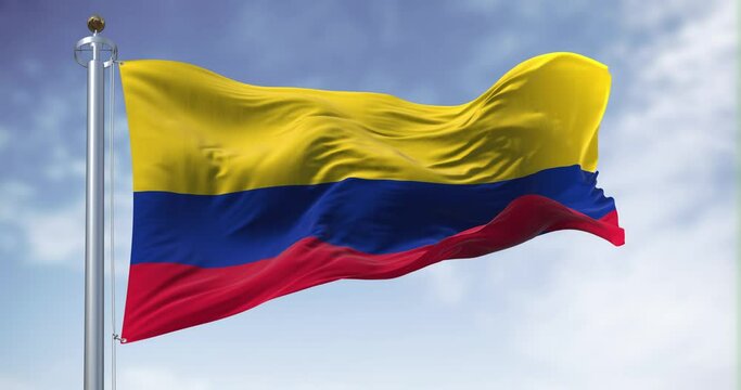 Seamless loop in slow motion of Colombia national flag waving in the wind