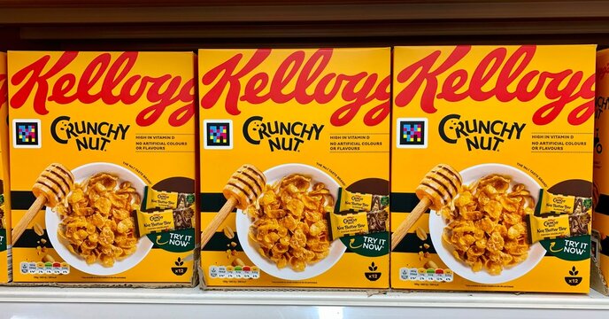 Essex, UK - March 31, 2023: Boxes of Kelloggs Crunchy Nut breakfast cereal on sale at a British supermarket. 