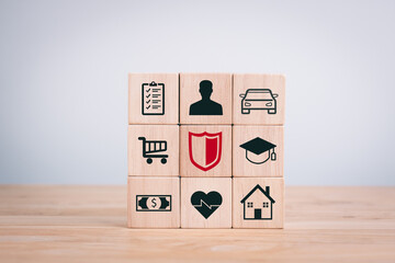 Concept of various types of insurance business. Wooden cubes with icons of car, money, health, support, real estate. Symbol on wooden cubes.
