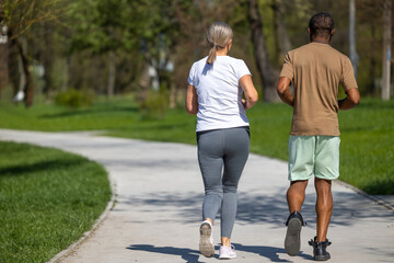 Mature couple jogging in the park together