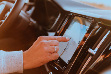 Close-up Of Man Hand Using GPS Navigation Inside Car